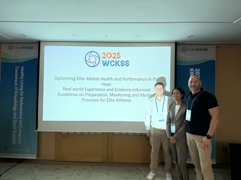 A group of people standing in front of a projector screen
AI-generated content may be incorrect.